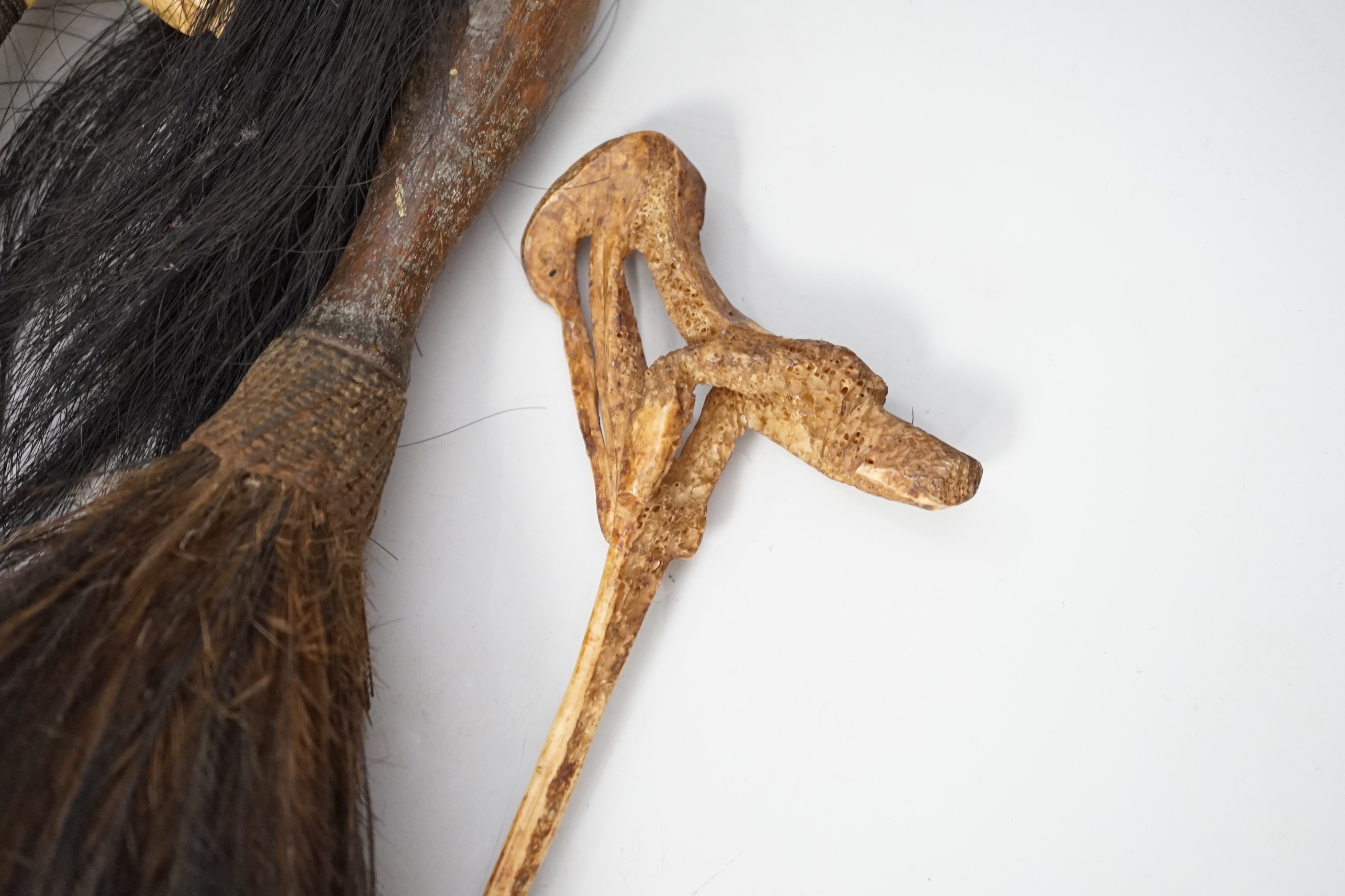 A Borneo 'headhunter's sword', a bone carving and feather swot (3), sword 77 cm long